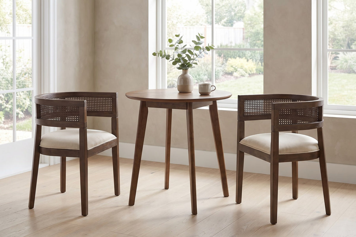 Ines cane barrel dining chair with a walnut-finish frame and beige seat in a bright breakfast nook