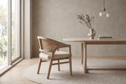 Louise rattan-back dining chair with a light ash rubberwood frame in a calm, daylit dining room