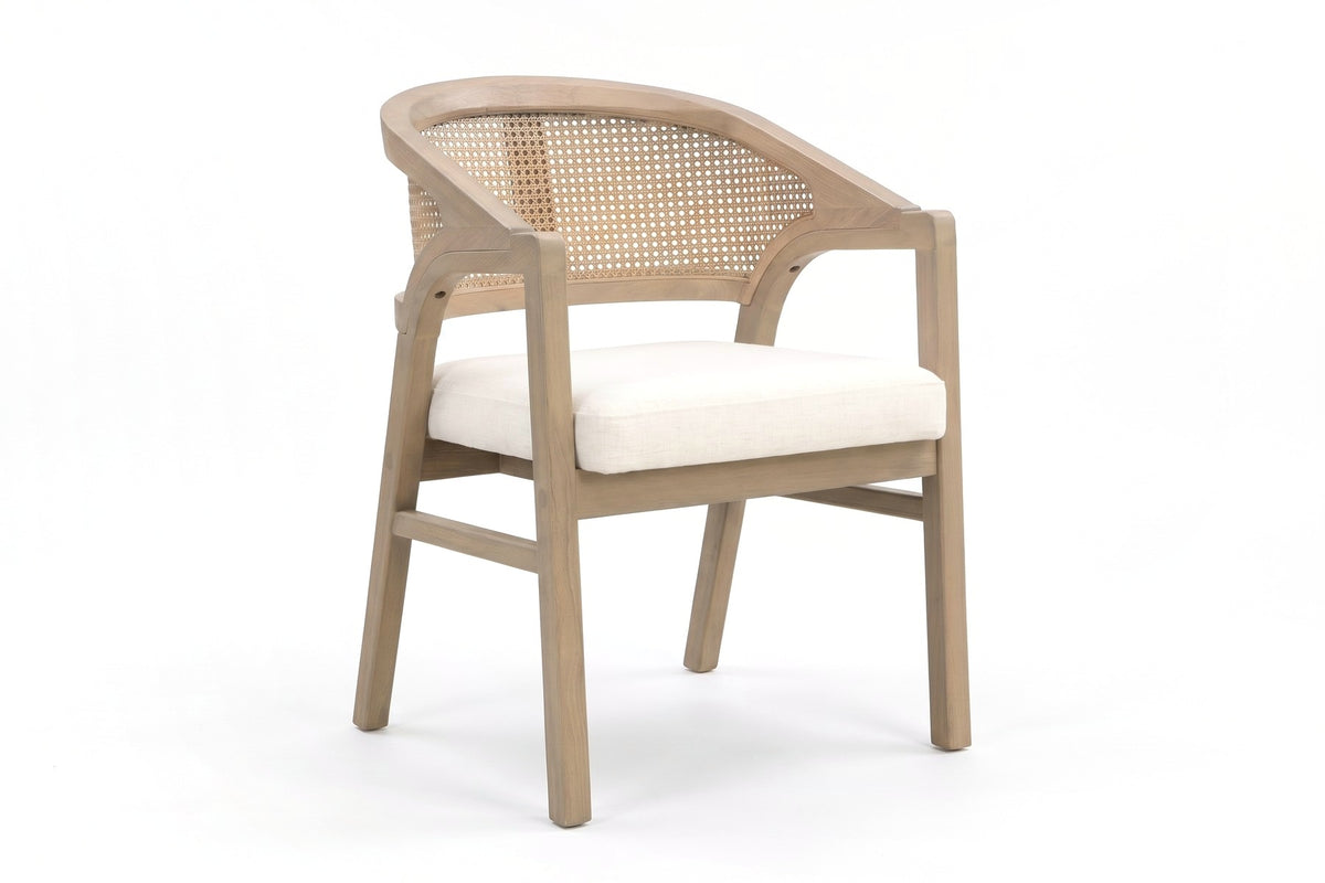 Louise rattan-back dining chair with a light ash rubberwood frame, three-quarter front view on a white background