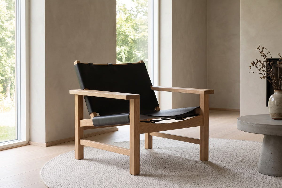 Lourmarin Leather Sling Chair in Black / Natural Oak, in a room setting