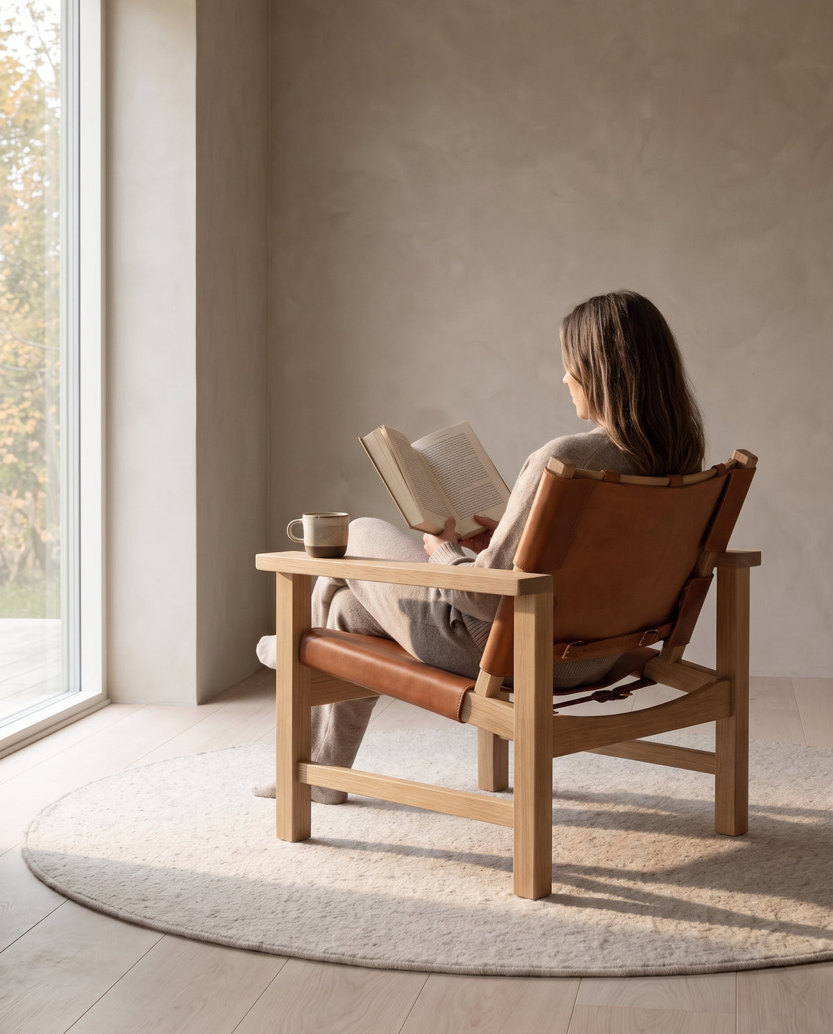 Lourmarin Cognac Leather Sling Chair on Natural Oak in everyday use at home