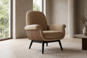 Lucie tan upholstered armchair with walnut-finish side panels and black legs in a calm, daylit living room