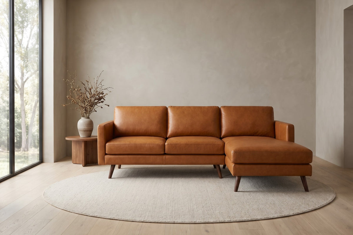 Luxembourg cognac tan leather l-sectional with right-facing chaise in a calm, daylit living room