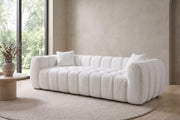 Madeleine 102.7" white bouclé channel-tufted sofa in a calm, daylit living room