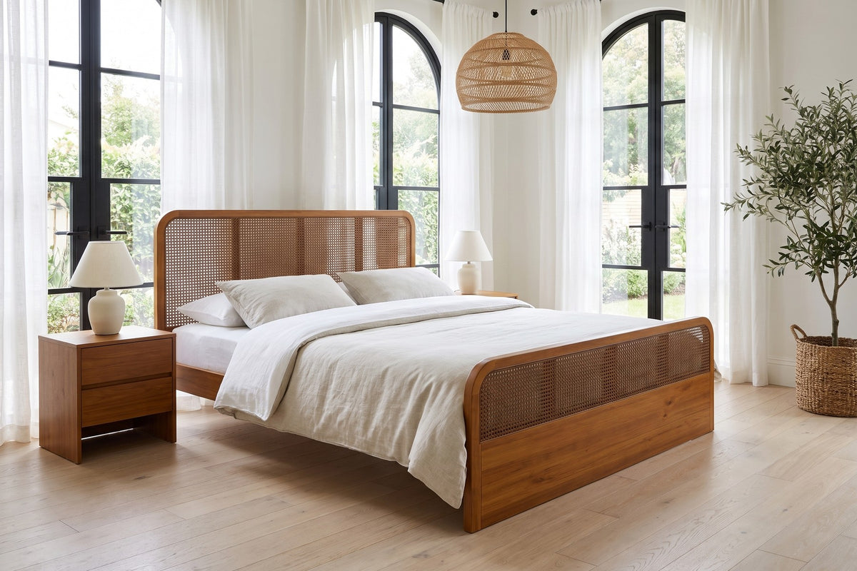 Malo walnut-finish solid wood platform bed with cane panels in a bright bedroom with tall arched windows
