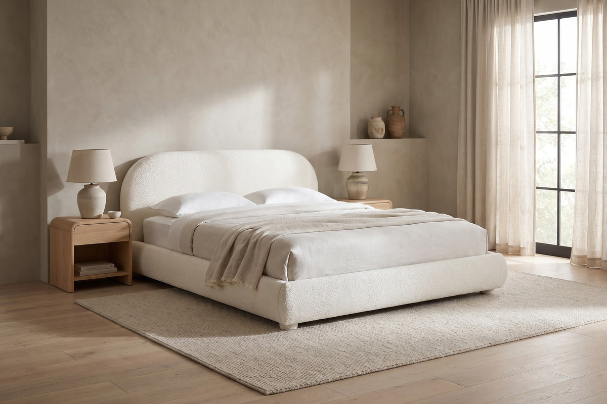 Manon cream bouclé bed with an arched headboard in a calm, daylit bedroom