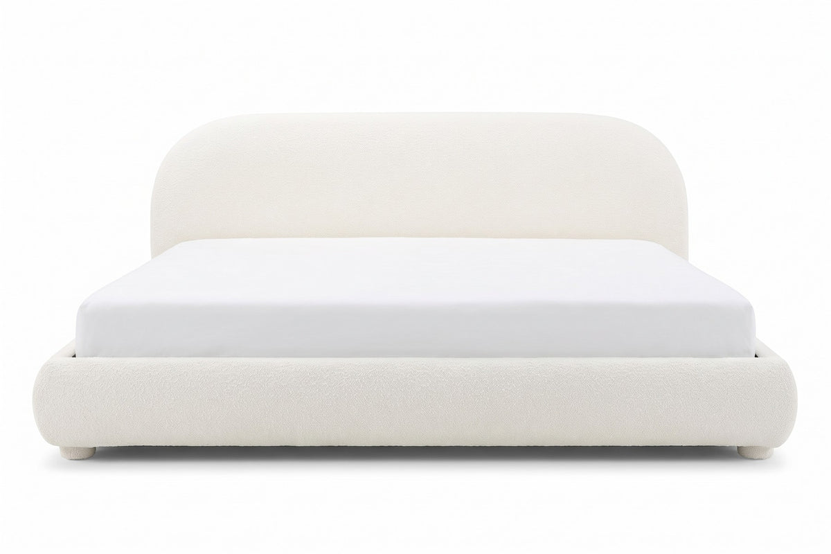 Manon cream bouclé bed with an arched headboard, straight front view from the foot of the bed, at mattress height on a white background