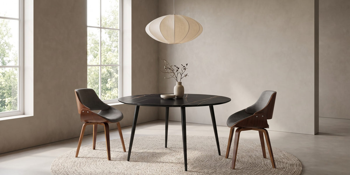 Marais round black sintered stone dining table with bentwood chairs in a calm daylit dining room with a paper pendant lamp
