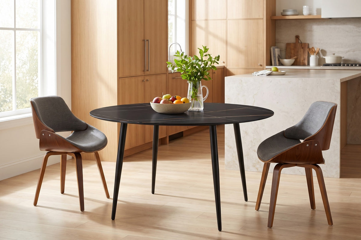 Marais round black sintered stone dining table with bentwood dining chairs in a bright open-plan kitchen