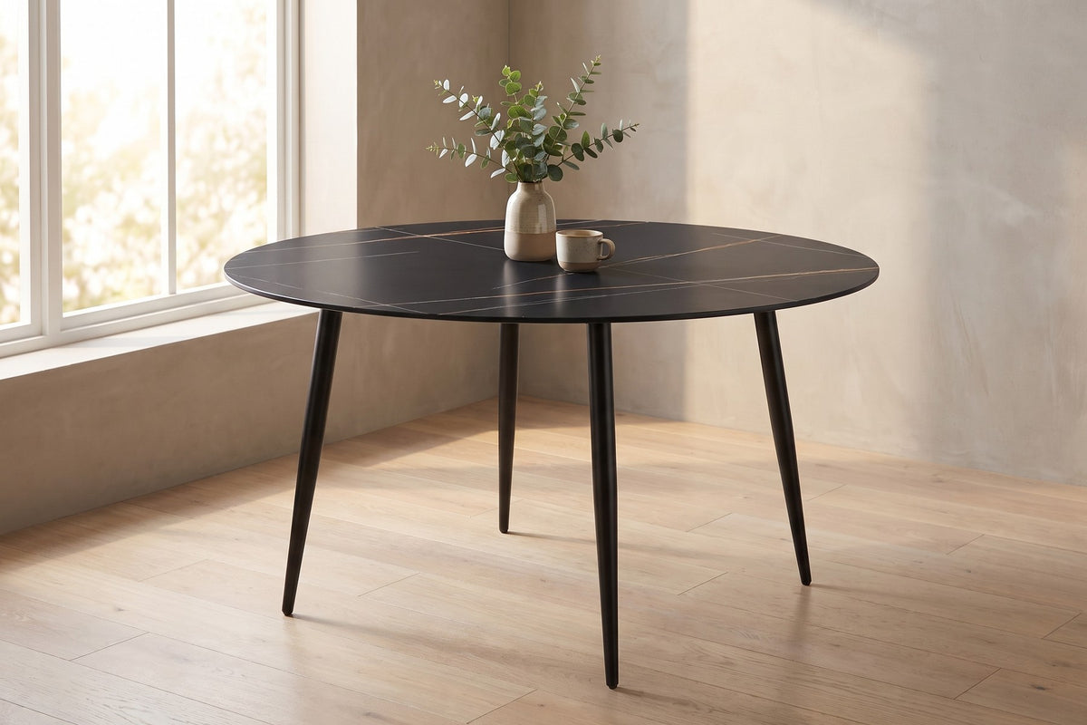 Marais round black sintered stone dining table in a sunlit breakfast nook