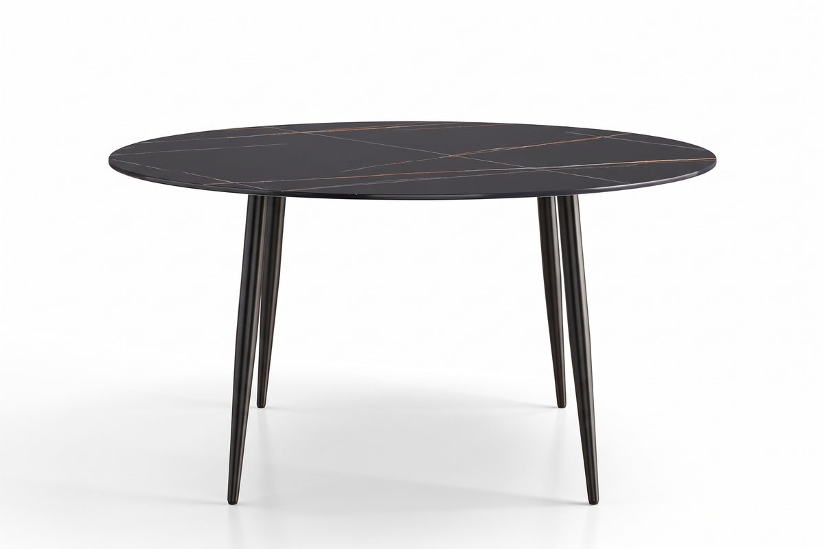 Marais round dining table side view showing four slim black splayed legs