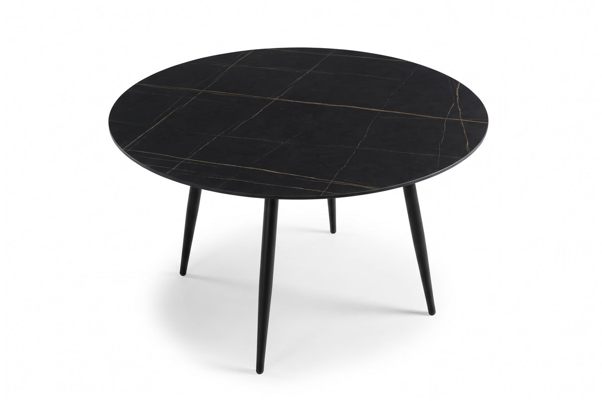 Marais round dining table seen from above, showing the black stone top with gold veining