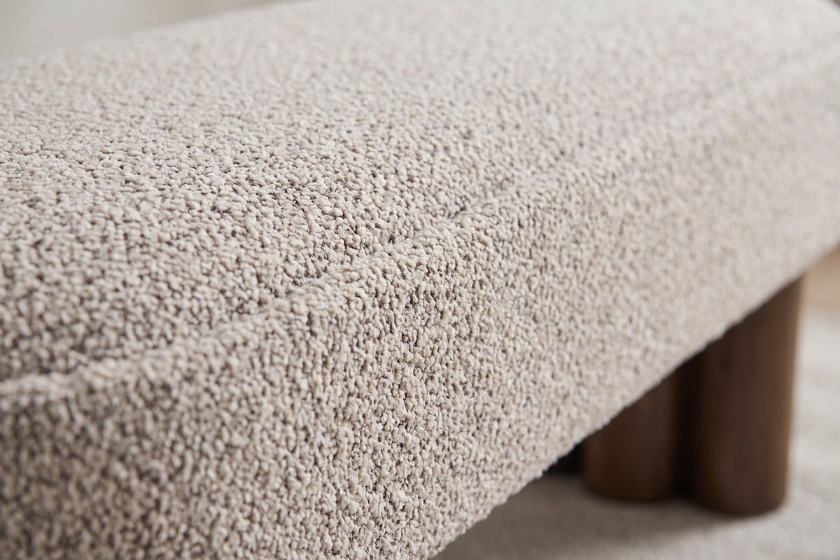 Close-up of the khaki bouclé cushion and its rounded edge