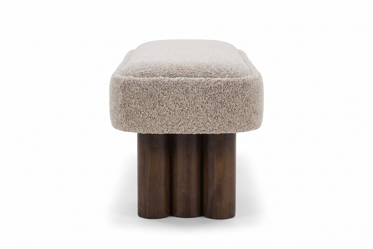 Margaux bouclé bench end view, showing a cluster of three walnut-finish legs