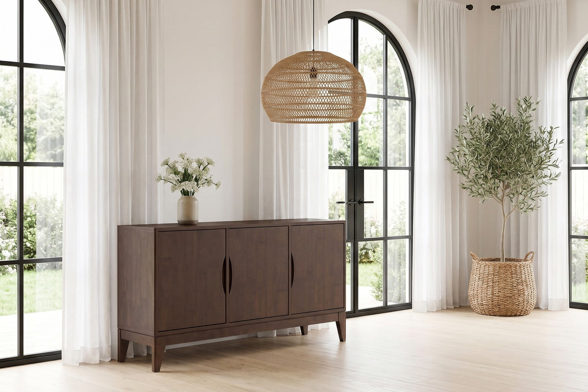 Daylight. Under tall arched windows, the sideboard anchors a bright, open wall.