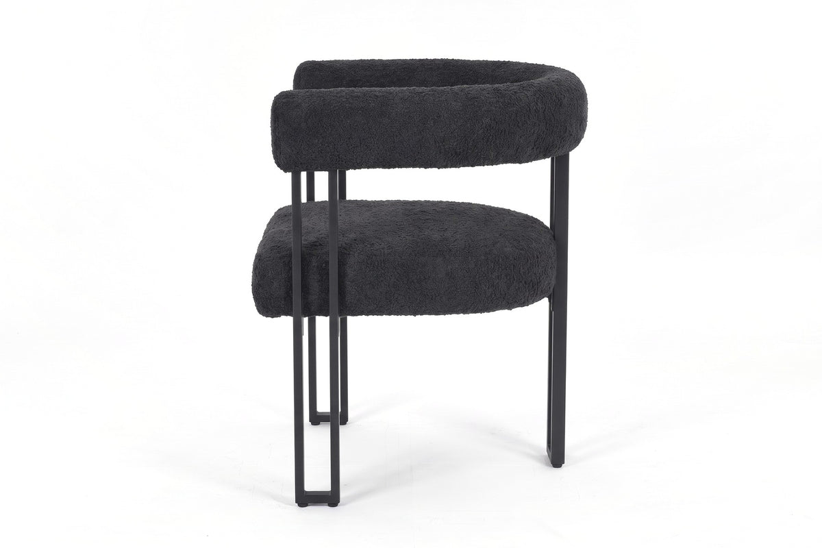 Mathilde black bouclé barrel dining armchair with black metal legs, straight side view on a white background
