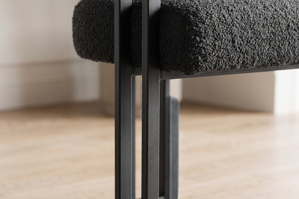 Close-up of the matte-black U-shaped double-bar back leg under the seat (Mathilde)