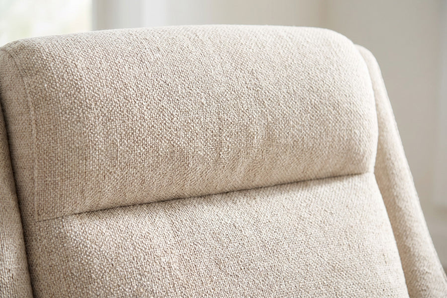 Megève Oatmeal Swivel Rocker Chair: close-up of the head roll at the top of the back and its horizontal seam, the oatmeal textured weave visible