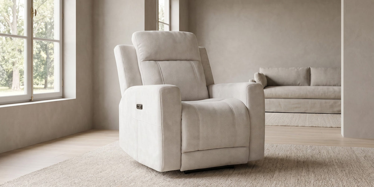 Mireille ivory chenille power recliner with channel-stitched back in a wide room view