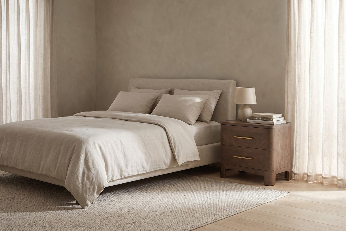 Monceau brown oak 2-drawer nightstand with rounded corners in a calm, daylit bedroom