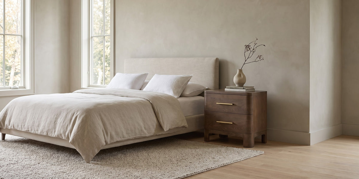 Monceau brown oak 2-drawer nightstand with rounded corners in a wide, calm bedroom