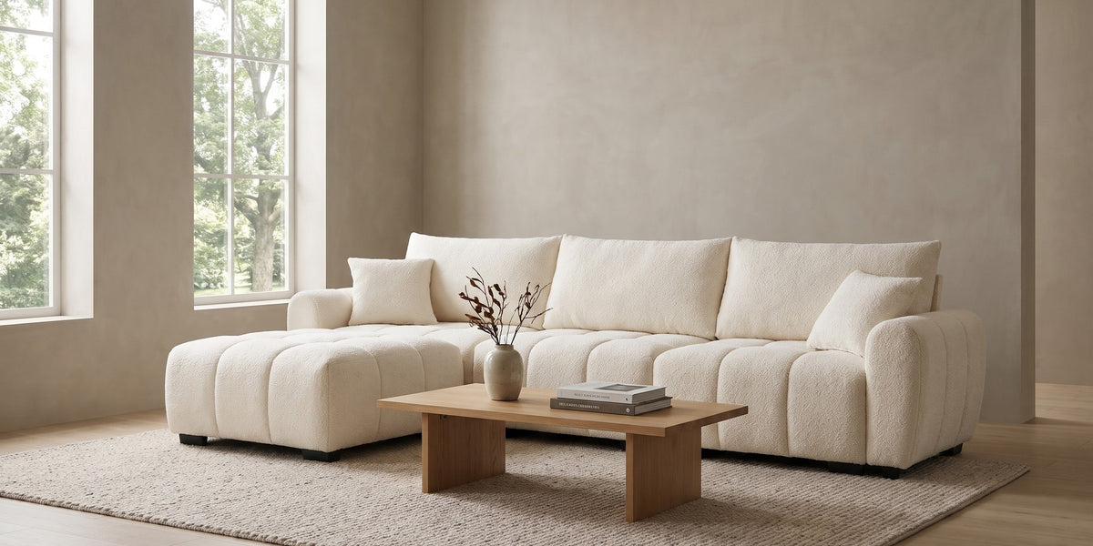 Montmartre 110" cream boucle modular sectional with movable ottoman in a wide room view