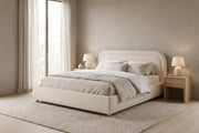 Nina beige-white bouclé platform bed with a rounded headboard in a calm, daylit bedroom