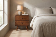 Noémie mid-century dark walnut 2-drawer nightstand in a calm bedroom in soft morning light, beside the bed