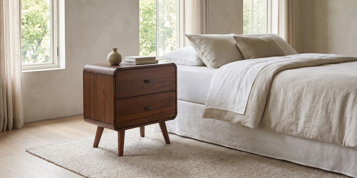 Noémie mid-century dark walnut 2-drawer nightstand in a wide room view
