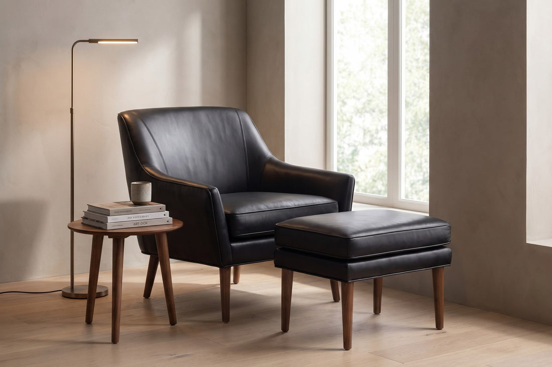 Nyons Leather Armchair and Ottoman in Black, in a living space