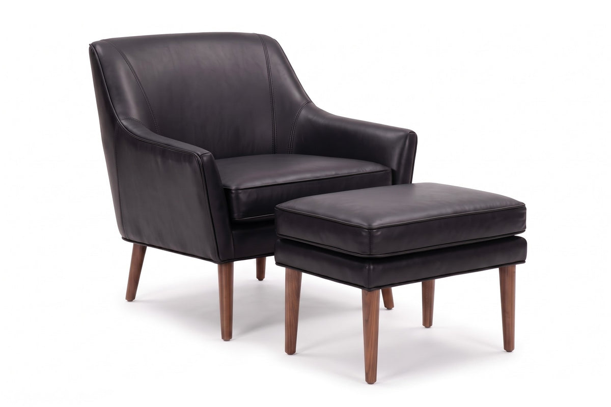 Nyons Leather Armchair and Ottoman in Black, three-quarter view on white