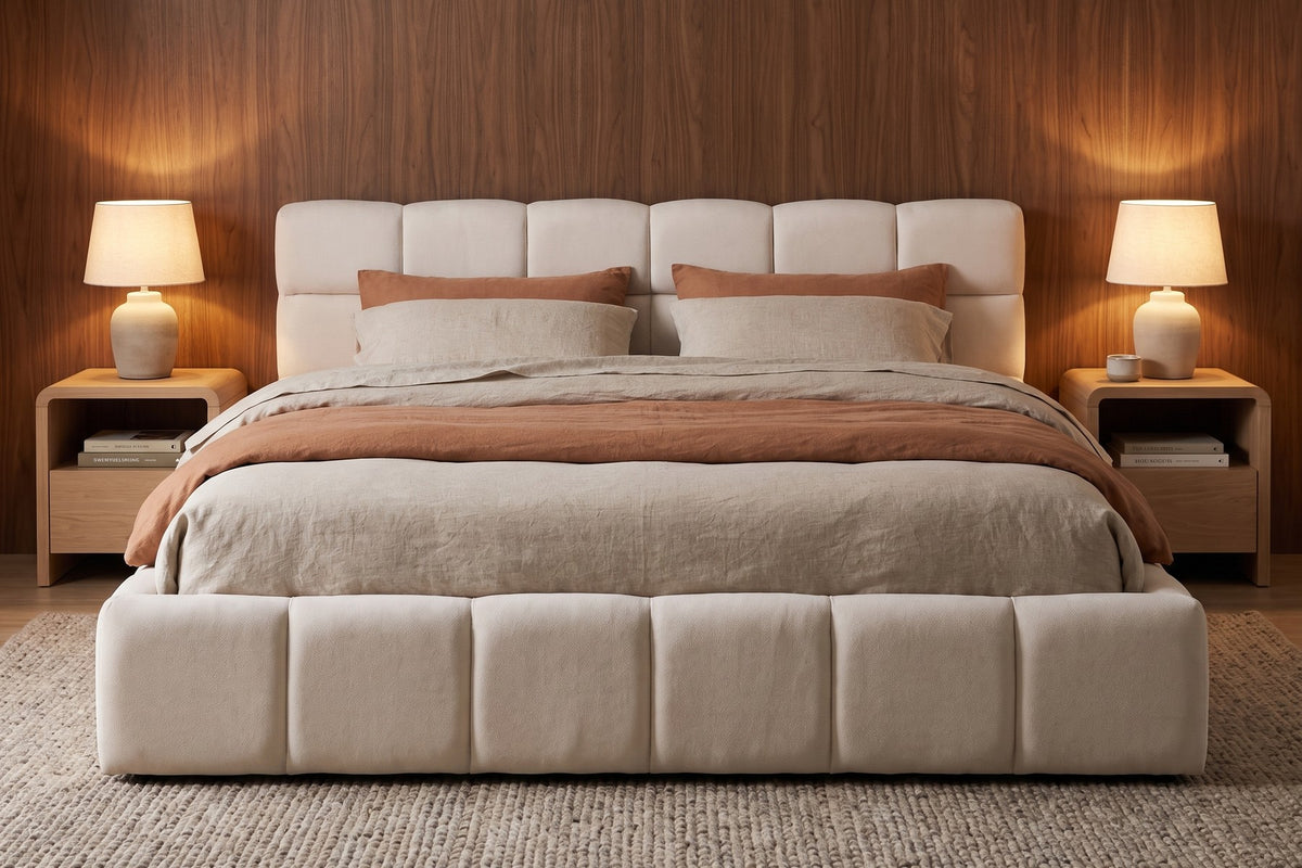 Odette cream-beige chenille queen bed with a square-tufted headboard in a warm walnut-panelled bedroom in the evening
