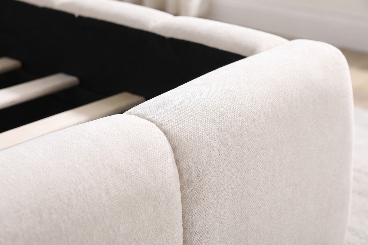 Close-up of one rounded corner of the foot rail where the padded blocks meet, showing the soft cream-beige chenille texture (Odette)