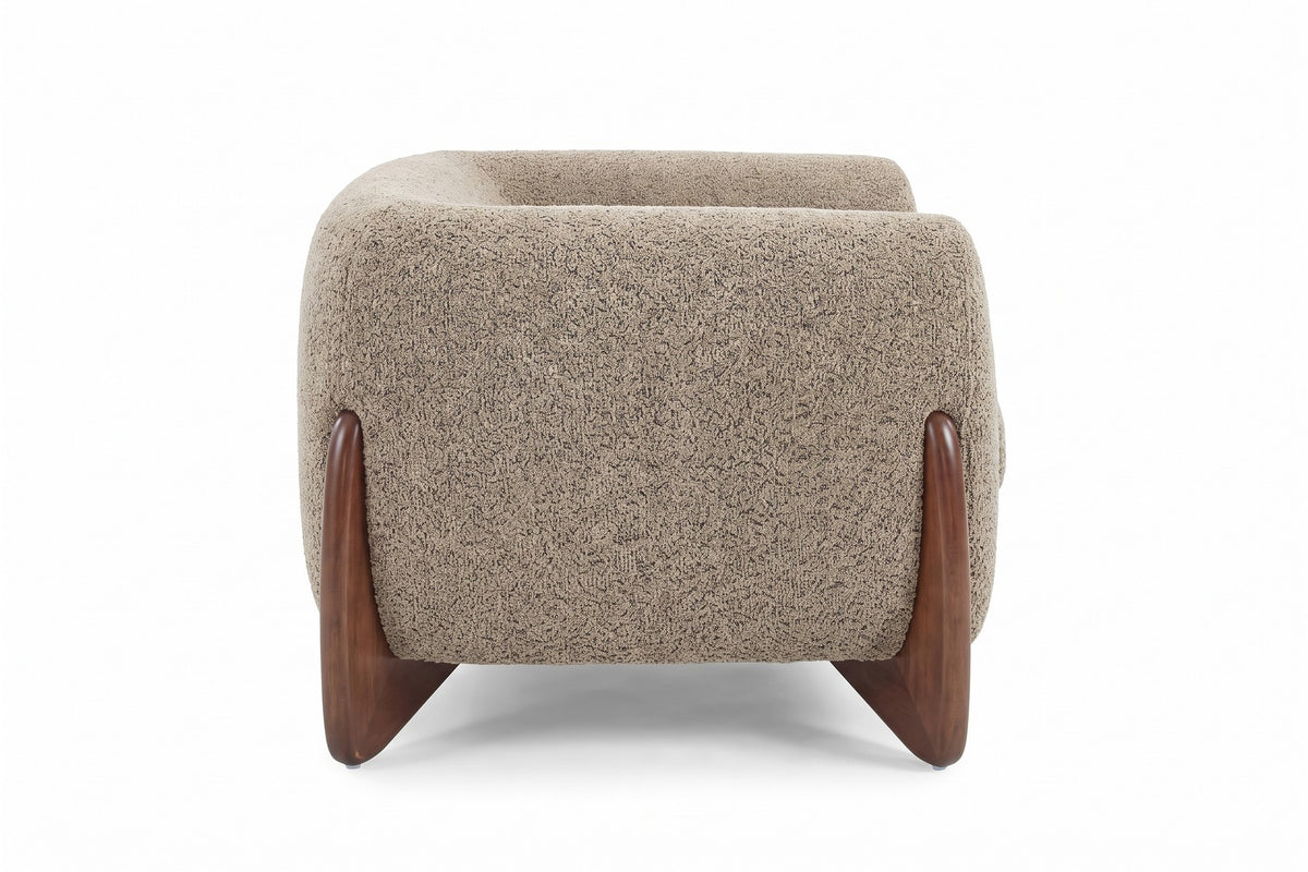 Passy light brown bouclé tuxedo accent chair with sculpted walnut-finish legs, straight side view on a white background
