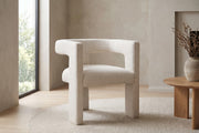 Picpus white bouclé sculpted accent chair with open back in a calm, daylit living room