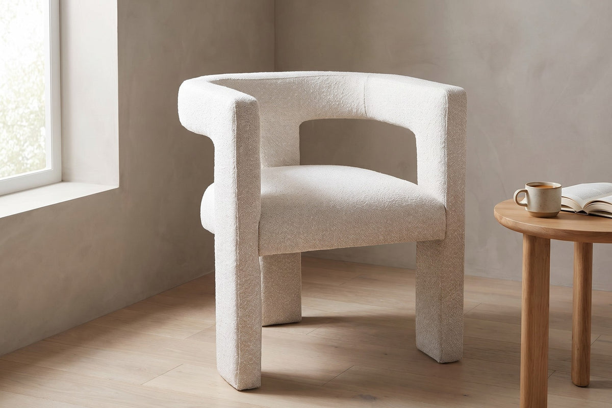 From the side, the open back curves around the seat like a soft sculpture.