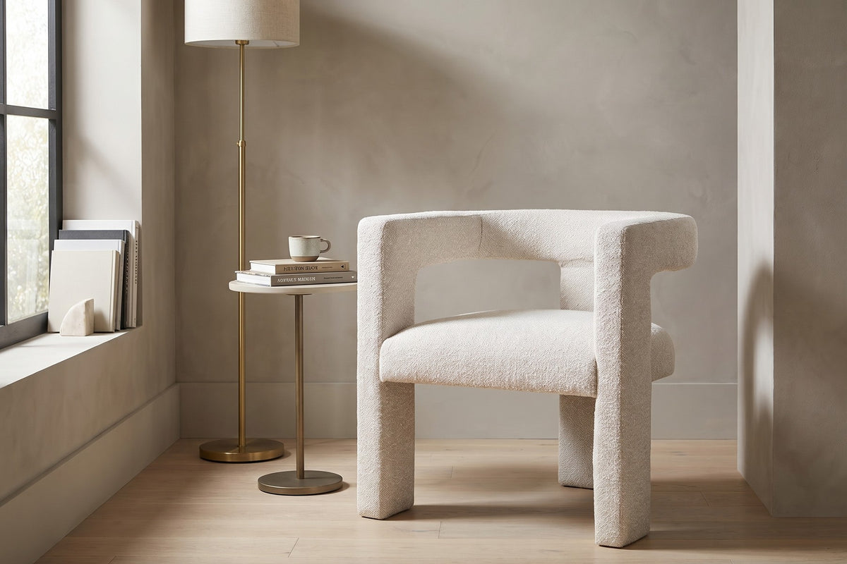 Picpus white bouclé sculpted accent chair with open back in a quiet reading nook by a tall window