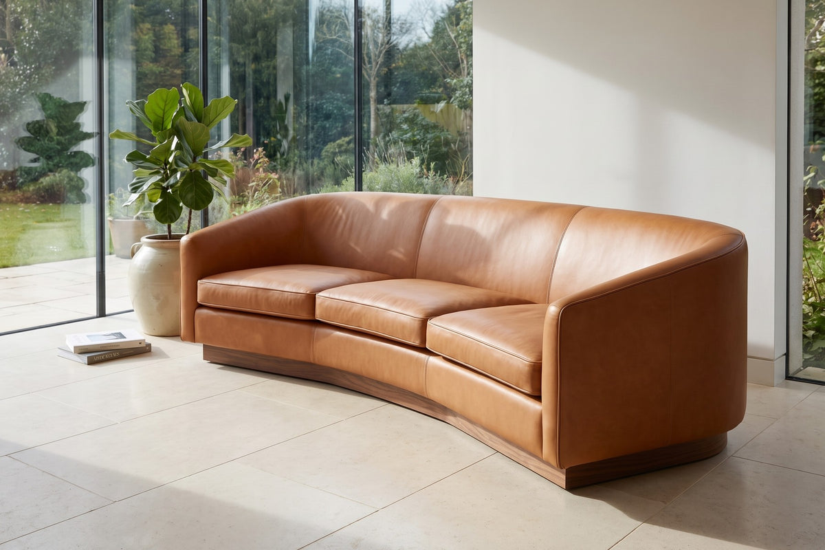 Pornic 94" Curved Leather Sofa – Crescent Back, Rounded Arms, Walnut-Finish Plinth