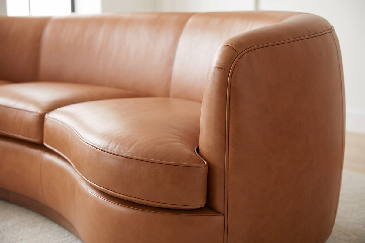 Pornic Cognac Curved Leather Sofa: close-up of a rounded arm end where the tight cognac leather back wraps round without a break