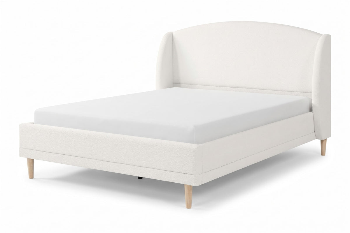 Sabine white bouclé bed with a wingback headboard and tapered wood legs, three-quarter front view from slightly above on a white background
