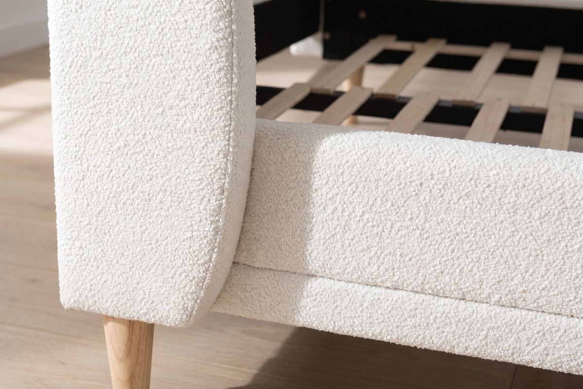 Close-up of one curved wing of the headboard in white bouclé where it meets the side rail (Sabine)