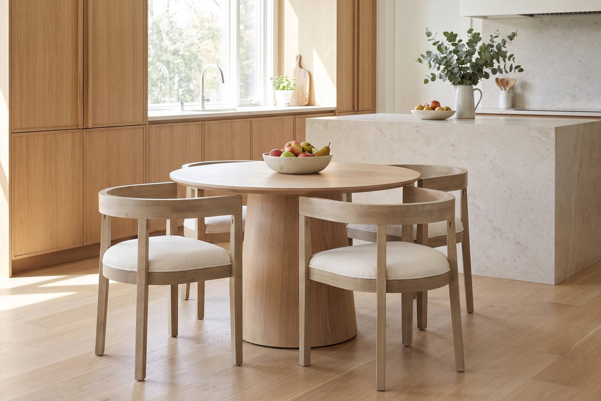 Simone horseshoe-back dining chair in light ash rubberwood with a beige seat in a bright open-plan kitchen and dining space