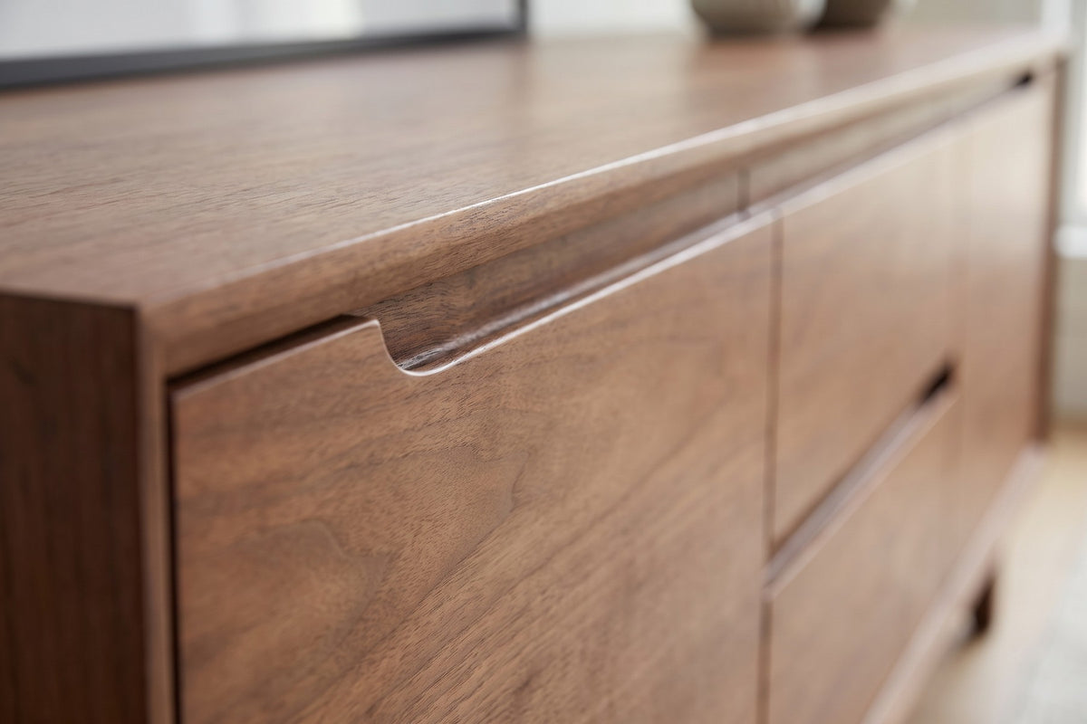 Valence Walnut Media Console: close-up of the routed finger-pull groove along the top edge of a door and a drawer, walnut grain visible