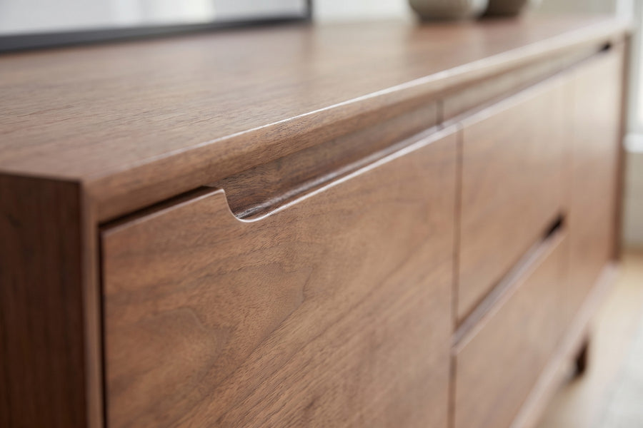 Valence Walnut Media Console: close-up of the routed finger-pull groove along the top edge of a door and a drawer, walnut grain visible