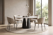 Valentine 59" round white sintered stone dining table on a black cone pedestal in a calm, daylit dining room