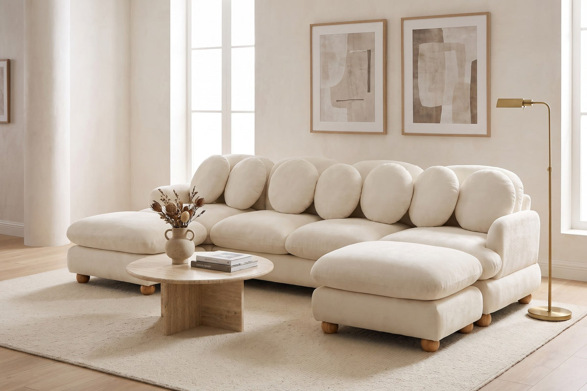 Daylight. Under framed prints, both ottomans pull up to make a deep lounge.