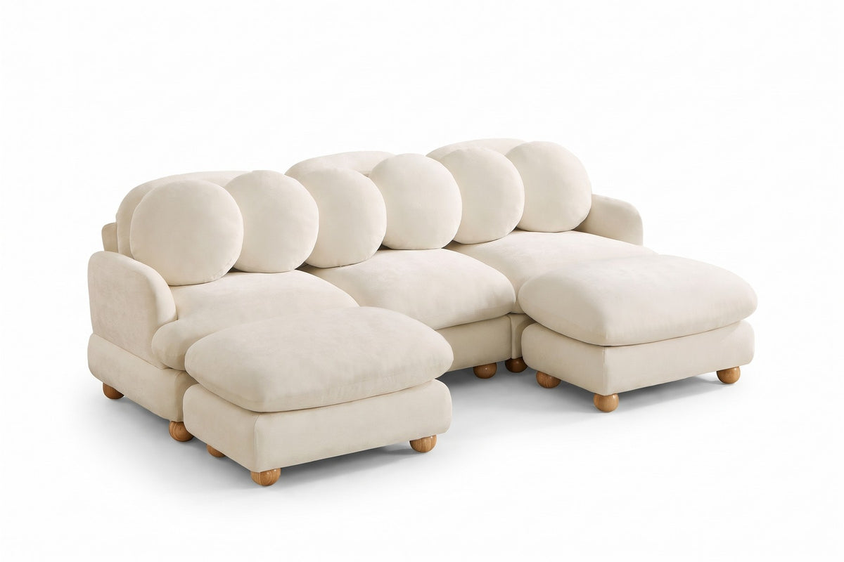 Vaugirard cream chenille modular u-sectional with round pillows and wood ball feet, three-quarter view on a white background