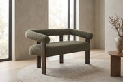 Victoire 53.25" green bouclé loveseat with round bolster arms in a calm, daylit living room